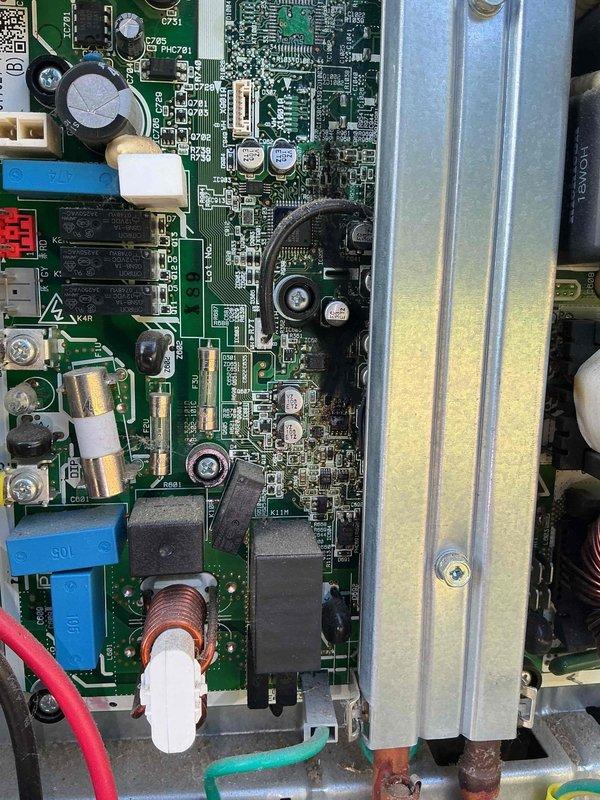 Responded to no cooling complaint on Unit 10 located at ground level. Customer reported outdoor unit making struggling sounds and failing to produce cold air. Upon inspection, accessed and photographed control board assembly revealing signs of component stress and potential electrical issues within the PCB system. Identified corrosion present on mounting chassis near circuit board connections. Documented complex wiring configuration including multiple capacitors, integrated circuits, and terminal connections for diagnostic purposes. Per customer instructions, system was shut down with fan left in operational mode to prevent further component damage pending repair authorization.