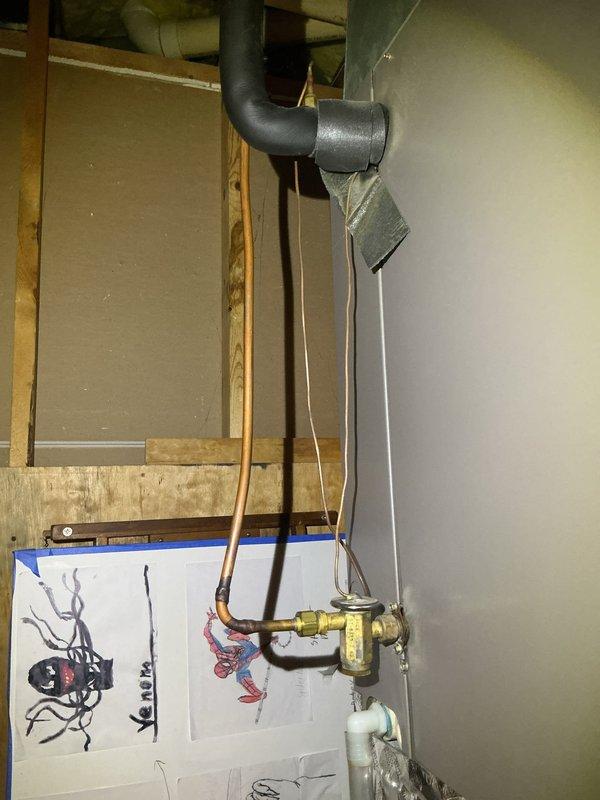 Responded to no cooling call on York condensing unit approximately one year old affecting entire home. Upon arrival, performed system diagnostics and inspected indoor evaporator coil and refrigerant lines in basement utility area. Verified proper electrical connections, checked refrigerant pressures, and assessed airflow through the system. System restored to normal cooling operation and confirmed adequate temperature differential across evaporator coil.