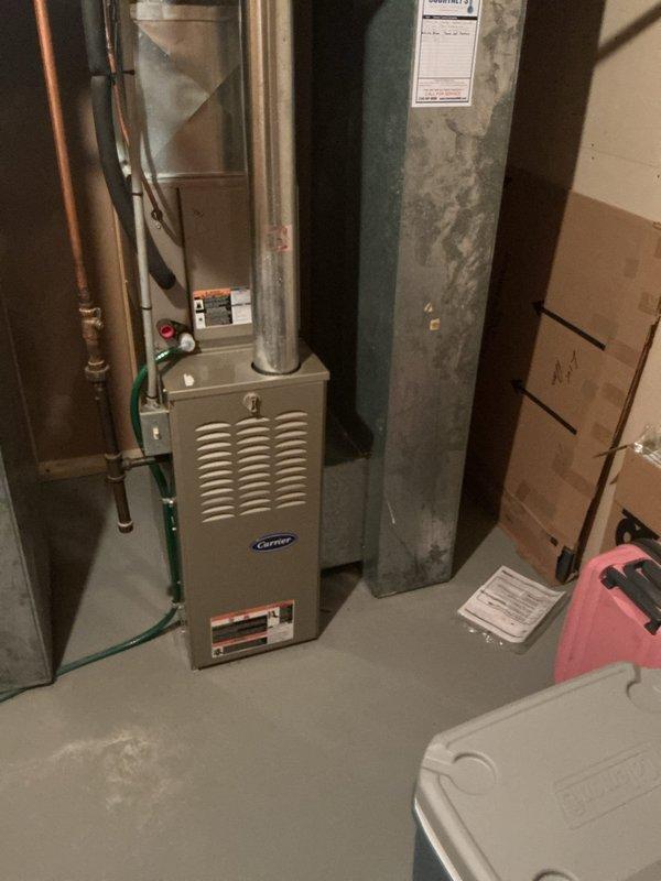 Responded to no-cool complaint on bedroom side of dual-zone system as follow-up to previous service visit. Upon inspection, discovered severely corroded copper refrigerant lines at air handler with heavy rust and oxidation indicating prolonged moisture exposure. Corrosion compromised refrigerant line integrity and system performance. Documented condition of Carrier furnace unit and associated HVAC components in basement mechanical room. Advised system requires refrigerant line replacement due to extensive deterioration beyond serviceable condition.