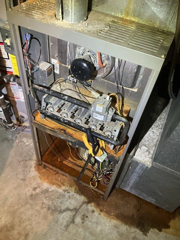 # HVAC System Inspection and Diagnostic Evaluation

Performed comprehensive inspection and diagnostic evaluation on residential Lennox furnace system located in basement utility area. Accessed internal components by removing front service panel to assess operational condition of heating equipment.

Conducted thorough visual examination of blower motor assembly, gas valve manifold, and electrical wiring connections. Utilized diagnostic testing equipment to measure system performance parameters and verify proper component function. Inspected burner assembly, heat exchanger accessibility, and internal safety controls for compliance with manufacturer specifications.

Evaluated external cabinet condition, noting accumulated dust and debris on ventilation grilles and exterior surfaces. Assessed ductwork connections and vapor barrier integrity surrounding furnace installation. Documented system specifications from manufacturer data plates for service records. Inspected surrounding plumbing in