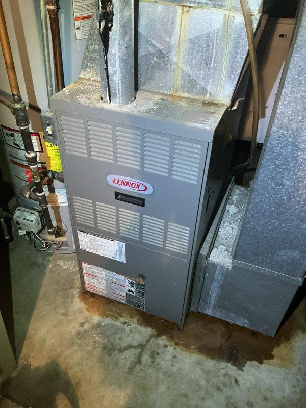 # HVAC System Inspection and Diagnostic Evaluation

Performed comprehensive inspection and diagnostic evaluation on residential Lennox furnace system located in basement utility area. Accessed internal components by removing front service panel to assess operational condition of heating equipment.

Conducted thorough visual examination of blower motor assembly, gas valve manifold, and electrical wiring connections. Utilized diagnostic testing equipment to measure system performance parameters and verify proper component function. Inspected burner assembly, heat exchanger accessibility, and internal safety controls for compliance with manufacturer specifications.

Evaluated external cabinet condition, noting accumulated dust and debris on ventilation grilles and exterior surfaces. Assessed ductwork connections and vapor barrier integrity surrounding furnace installation. Documented system specifications from manufacturer data plates for service records. Inspected surrounding plumbing in
