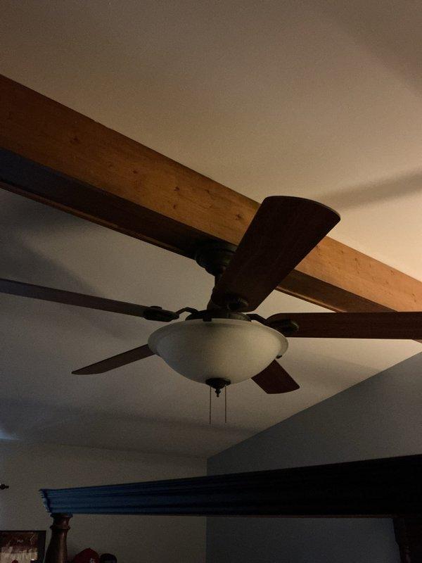 Completed electrical estimate for installation of three ceiling fans in two bedrooms. Site assessment confirmed existing electrical boxes and wiring capacity for fan installations. Documented current ceiling configurations including standard flat ceiling in one bedroom and vaulted ceiling with exposed beams in second bedroom, which will require appropriate mounting hardware and downrod extensions for proper clearance and operation.