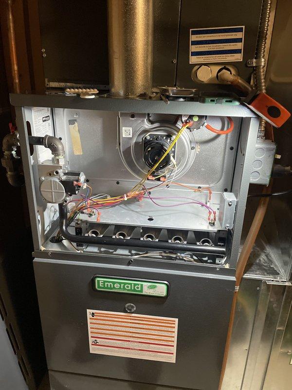 Performed comprehensive HVAC Supertune maintenance on 15-year-old Emerald brand furnace and air conditioning system. Conducted thorough inspection of all internal components including blower motor assembly, gas burner tubes, ignition system, and electrical connections. Verified proper operation of all colored wiring harnesses and control circuits throughout the unit. Inspected and evaluated mesh filter condition in blue air handler housing, confirming adequate airflow. Checked condensate drainage line for proper function and verified all ductwork connections. All system components found operating within normal parameters with no immediate service needs identified.