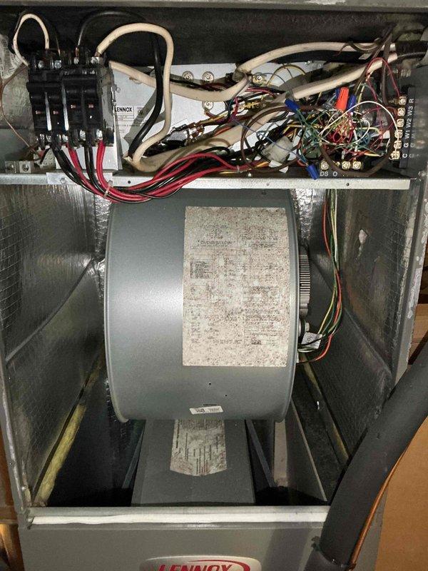 # HVAC Cooling System Tune-Up Summary

Performed comprehensive preventive maintenance on ground-mounted air conditioning unit. Inspection revealed moderate dust accumulation on blower motor assembly and electrical components requiring attention.

# Work Performed

Conducted thorough visual inspection of electrical control compartment, verifying all wire connections, contactor operation, and capacitor condition. Examined control board terminals and wiring integrity throughout upper compartment. Assessed blower motor assembly, noting dust buildup on motor housing and surrounding cabinet areas.

Performed operational diagnostics using calibrated test equipment. Measured system pressures and temperatures with digital manifold gauge set, recording refrigerant pressures and superheat values. Monitored supply air temperature at grille, confirming proper airflow and cooling performance. All readings indicated system operating within manufacturer specifications.

Cleaned blower motor housing an