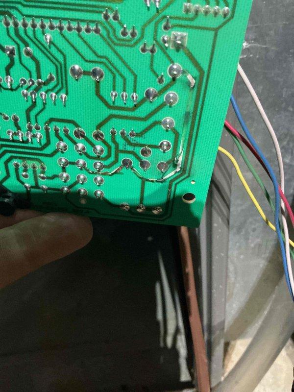 Returned to property to diagnose electrical short in first floor air conditioning system as previously noted. Inspected furnace control board and traced wiring connections to locate short circuit. Examined Lennox SL13-AC1S outdoor condensing unit and verified electrical components. Documented circuit board condition and wiring harness for repair recommendations on two-unit system.