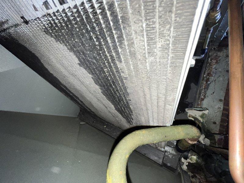 Responded to callback for AC system not cooling entire house after previous service attempt. Inspected 10-year-old air handler unit and refrigerant lines in attic space, documenting existing insulation condition and mechanical connections. Customer advised unit was shut off and using alternative cooling methods; discussed replacement options given system age and recurring failure, with customer expressing willingness to proceed without waiting for off-season.