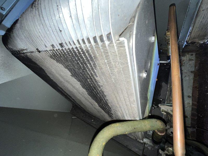 Responded to callback for AC system not cooling entire house after previous service attempt. Inspected 10-year-old air handler unit and refrigerant lines in attic space, documenting existing insulation condition and mechanical connections. Customer advised unit was shut off and using alternative cooling methods; discussed replacement options given system age and recurring failure, with customer expressing willingness to proceed without waiting for off-season.