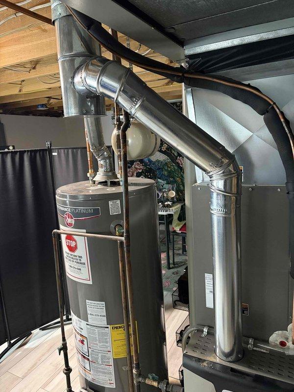 Completed flue repair on water heater system by replacing deteriorated venting components. Installed 6 feet of 4-inch flue pipe and one 4-inch elbow to restore proper venting from water heater to chimney. Verified proper draft and confirmed heating system operational upon completion.