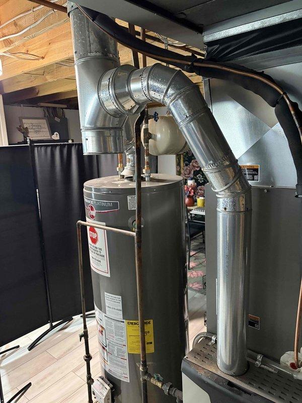 Completed flue repair on water heater system by replacing deteriorated venting components. Installed 6 feet of 4-inch flue pipe and one 4-inch elbow to restore proper venting from water heater to chimney. Verified proper draft and confirmed heating system operational upon completion.