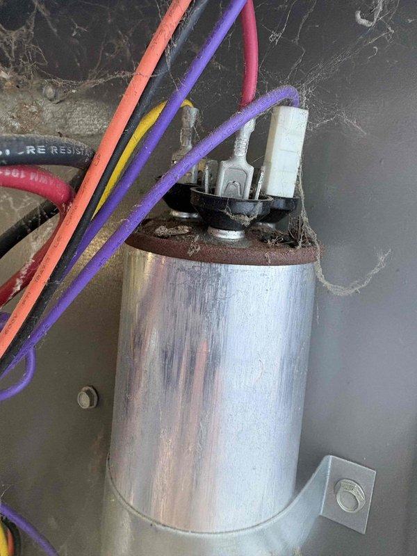 Responded to no cooling complaint on ground-level garage unit. Upon inspection, found heavily soiled air filter with significant dust and debris accumulation restricting airflow, along with a capacitor showing visible weathering and discoloration. Advised customer to shut off AC system and leave fan running to prevent further strain on equipment until repairs could be completed.