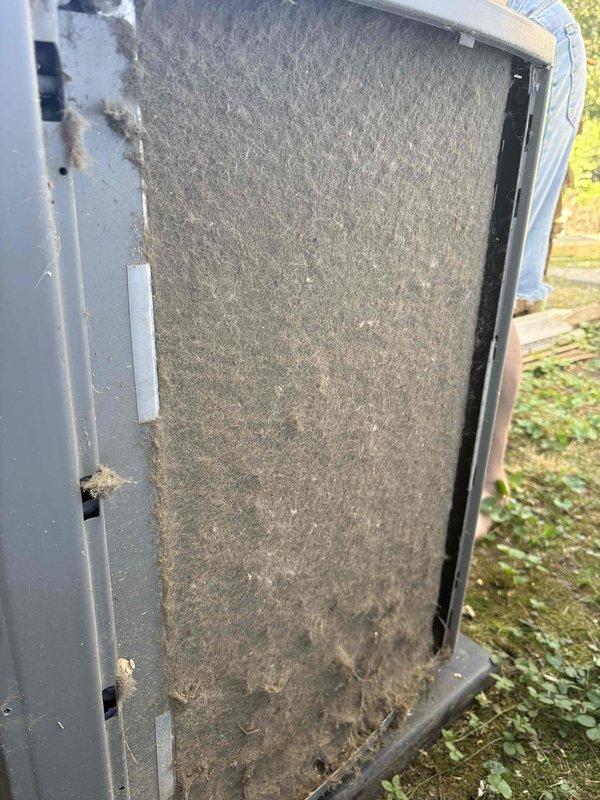 Responded to no cooling complaint on ground-level garage unit. Upon inspection, found heavily soiled air filter with significant dust and debris accumulation restricting airflow, along with a capacitor showing visible weathering and discoloration. Advised customer to shut off AC system and leave fan running to prevent further strain on equipment until repairs could be completed.