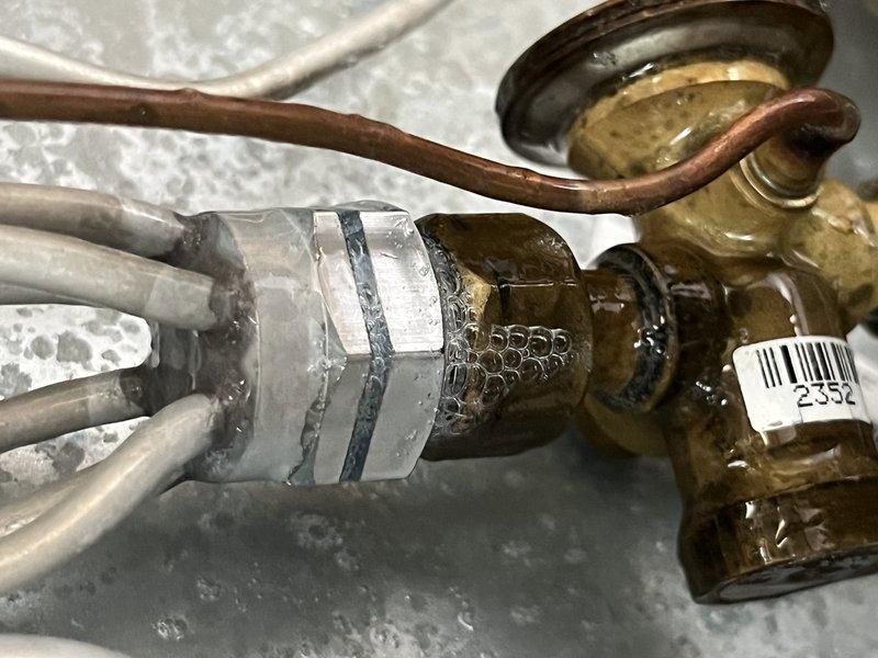 Responded to no cooling complaint on 2024 system. Upon arrival, performed diagnostic evaluation of outdoor unit and associated components. Inspected refrigerant lines, service valves, and system connections as shown in documentation photos. Unit was recently installed as complete system replacement. Verified proper installation of refrigerant line connections, service port access, and valve configurations. System evaluated for proper refrigerant charge, electrical connections, and operational parameters to restore cooling function.