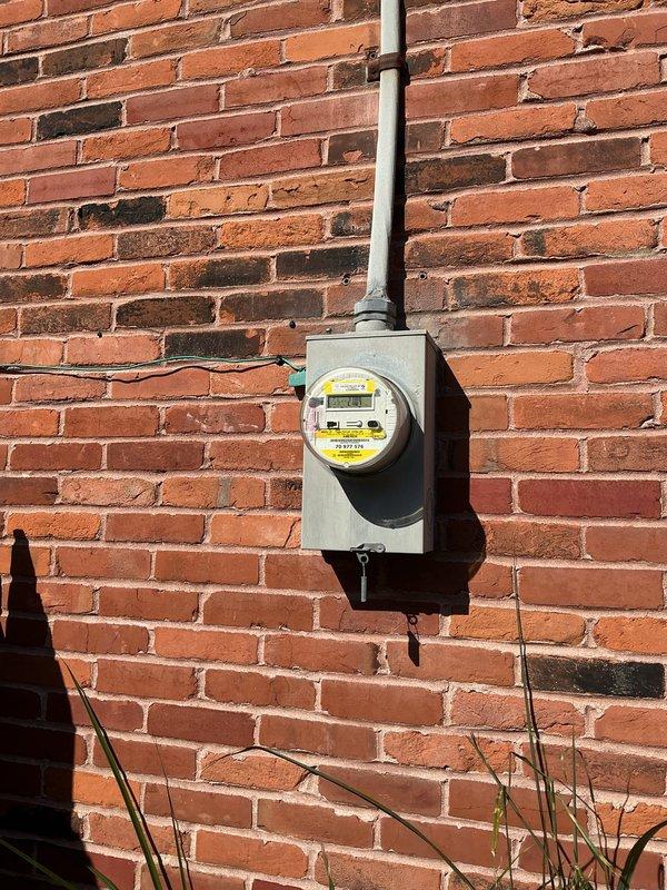 Relocated existing exterior electrical connection from shed-mounted position to fence post approximately four feet away. Disconnected and safely removed electrical components from original mounting location, repositioned hardware to new fence post mount, and reconnected all wiring to maintain proper service continuity. Verified secure installation and proper electrical function at relocated connection point.