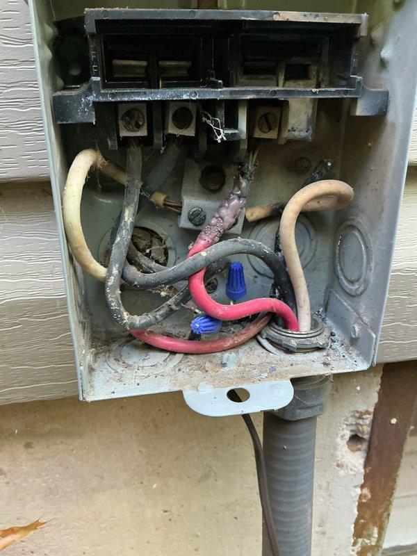 Responded to no cooling call on 24-year-old air conditioning system. Upon arrival, found outdoor unit not operating while indoor blower was running normally. Inspected outdoor disconnect box and discovered deteriorated wiring connections with significant age-related degradation, loose wire terminations, and accumulated debris within the enclosure. Identified compromised electrical connections at terminal block preventing proper power delivery to compressor and condenser fan motor. Cleaned and re-terminated all electrical connections, replaced degraded wire nuts, and secured all conductors properly within disconnect box. Verified proper voltage at unit, restored power, and confirmed compressor and outdoor fan motor operation. System cycled on properly and began cooling effectively. Recommended monitoring system performance and consideration for unit replacement due to advanced age of equipment.