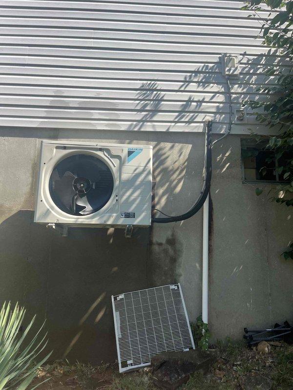 Returned to site during daylight hours to diagnose Daikin outdoor condenser unit mounted in compact, elevated wall-bracket installation with limited access. Conducted thorough visual inspection of wall-mounted unit, refrigerant line connections, and electrical components including exterior disconnect box. Completed diagnostic assessment of the system and provided detailed repair quote to customer for identified issues.