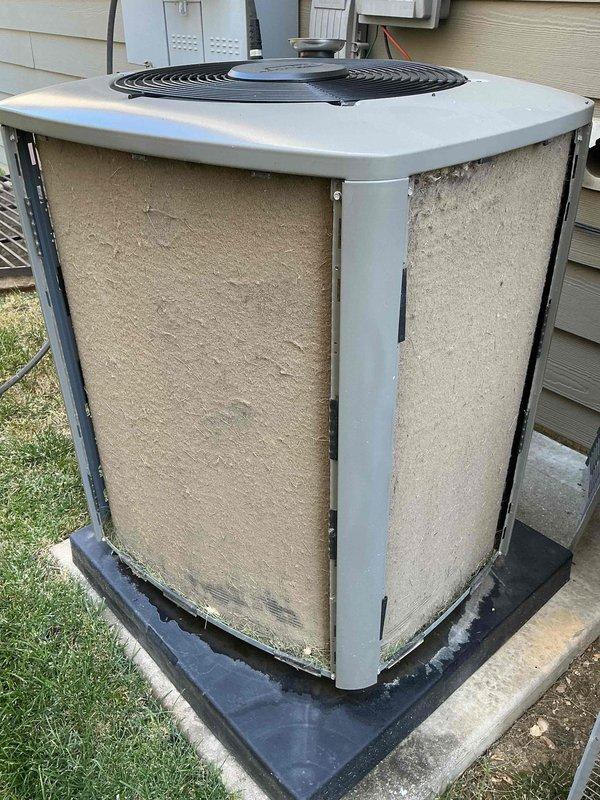 Completed preventative maintenance tune-up on a single residential air conditioning system located on the side of the home. Performed comprehensive inspection of the outdoor condenser unit, which showed normal weathering and operational condition with minor dirt accumulation on lower panels. Unit is properly positioned on rubber isolation pad with adequate clearance for airflow and service access, with electrical disconnect and components properly mounted on exterior wall.