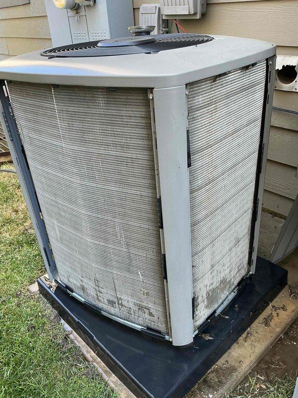 Completed preventative maintenance tune-up on a single residential air conditioning system located on the side of the home. Performed comprehensive inspection of the outdoor condenser unit, which showed normal weathering and operational condition with minor dirt accumulation on lower panels. Unit is properly positioned on rubber isolation pad with adequate clearance for airflow and service access, with electrical disconnect and components properly mounted on exterior wall.