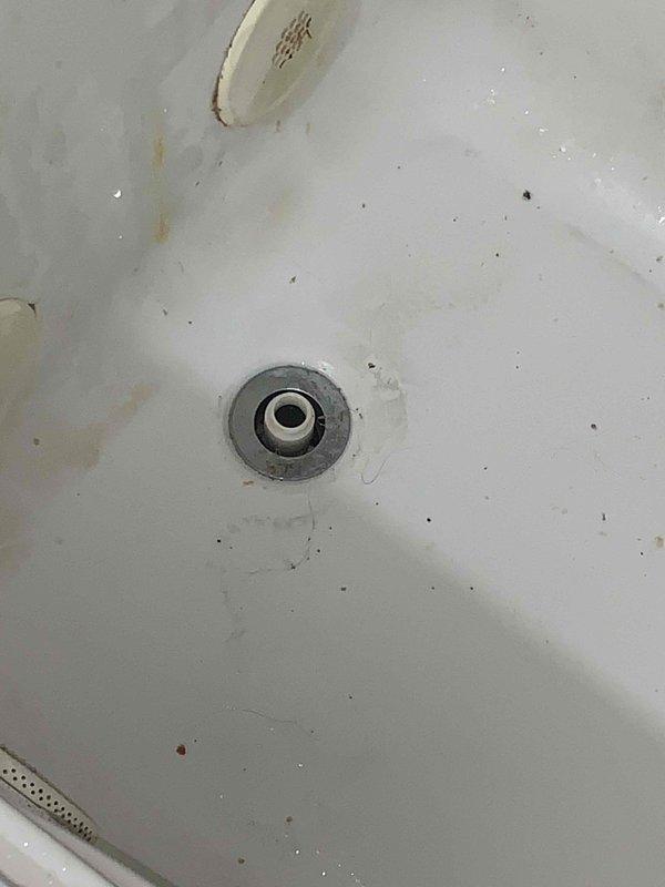Responded to service call for clogged bathtub drain. Upon arrival, assessed the bathroom sink and drain assembly, which showed signs of age and accumulated buildup. Successfully cleared the drain obstruction and restored proper water flow. Documented pre-existing condition of fixtures, including visible wear, mineral deposits, and discoloration on porcelain surfaces and mounting hardware. Drain is now functioning properly with no further blockage issues observed at time of service completion.