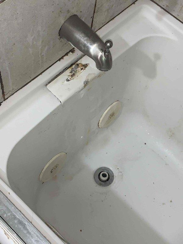 Responded to service call for clogged bathtub drain. Upon arrival, assessed the bathroom sink and drain assembly, which showed signs of age and accumulated buildup. Successfully cleared the drain obstruction and restored proper water flow. Documented pre-existing condition of fixtures, including visible wear, mineral deposits, and discoloration on porcelain surfaces and mounting hardware. Drain is now functioning properly with no further blockage issues observed at time of service completion.