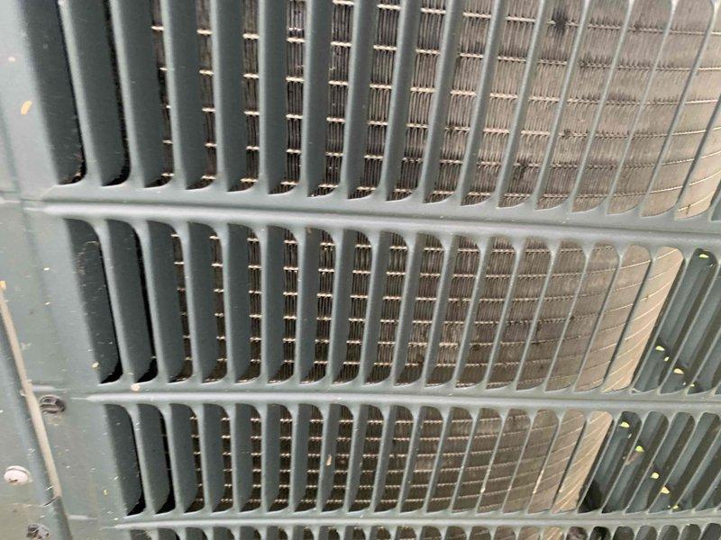 Returned to address no cooling issue on single AC unit following previous day's visit where dirty filter and coil were identified. Customer had replaced filter but did not clean outdoor condenser coil. Upon arrival, confirmed unit was off with fan running as instructed. Inspected outdoor condenser unit and documented heavily restricted coil with significant accumulation of dirt, dust, and fibrous debris blocking airflow between fins. Cleaned condenser coil to restore proper heat exchange capacity and airflow. Verified system operation and cooling performance restored to normal parameters.
