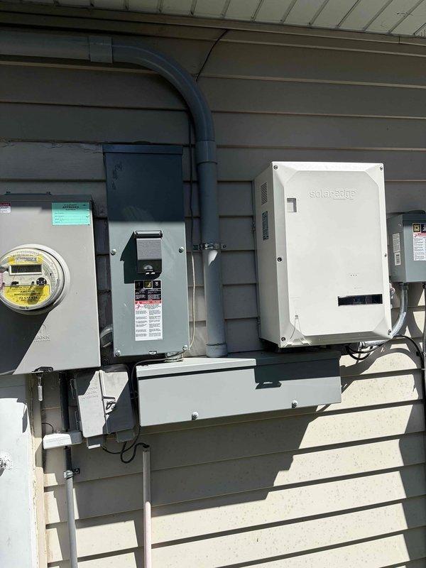 Performed comprehensive electrical estimate for outlets and breaker box installation. Conducted voltage testing on existing outlet using Klein Tools RT250 tester, confirming proper 118 VAC reading and correct wiring configuration. Assessed exterior electrical service panel, meter base, and solar power system integration including SolarEdge inverter and associated conduit routing for potential upgrade requirements.