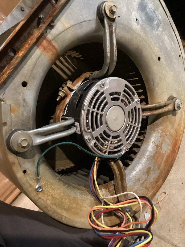 Replaced failed blower motor with OEM unit to restore cooling operation. Removed temporary rescue motor that was previously installed, completed all electrical connections with proper color-coded wiring, and verified blower assembly operation within specifications. Disposed of defective motor per standard procedures.