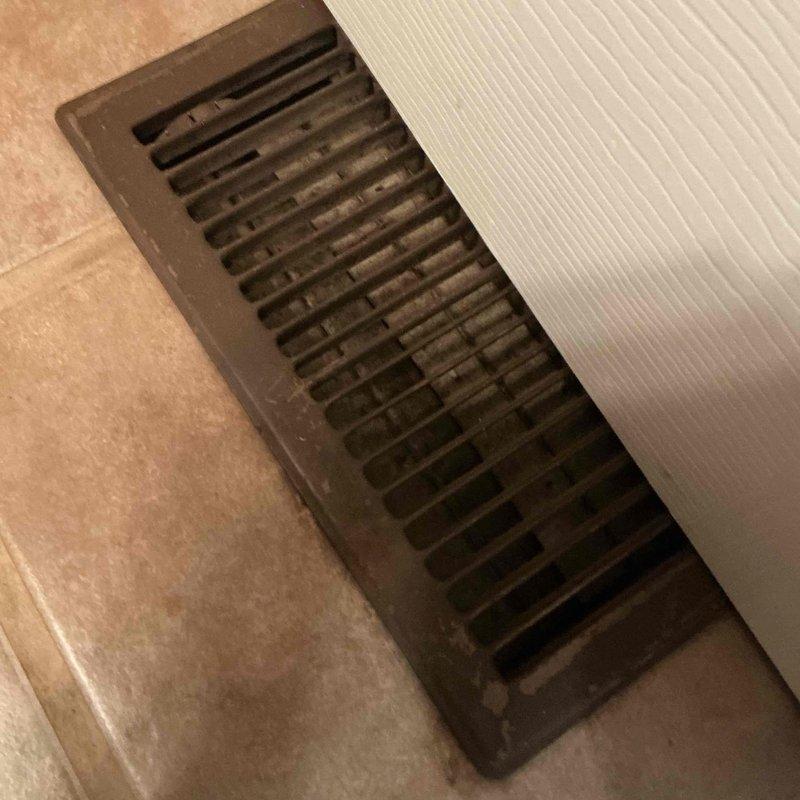 Responded to service call for iced-over condenser unit. Upon arrival, confirmed outdoor condensing unit had excessive ice buildup on coils and refrigerant lines. Advised customer to power down system immediately to prevent compressor damage and allow ice to thaw completely. Inspected interior supply registers and documented airflow conditions at multiple locations throughout the home. Found restricted airflow at floor vents with visible dust accumulation, indicating potential filter restriction or low refrigerant charge contributing to freeze-up condition. System requires follow-up visit after complete thaw to diagnose root cause, check refrigerant levels, inspect evaporator coil, verify proper airflow, and test system operation.