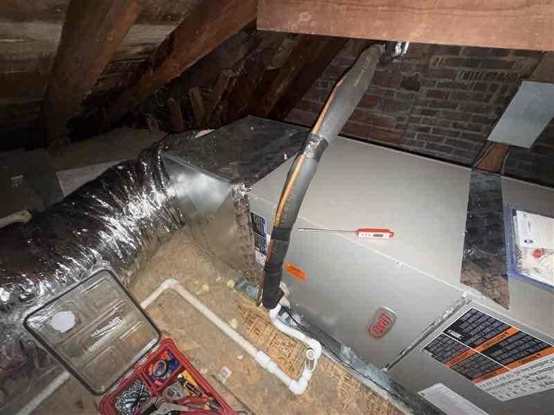 Responded to callback for second floor air conditioning failure on recently installed Lennox system (May 2024). Inspected attic-mounted air handler and associated components including refrigerant lines, condensate drainage, and ductwork connections. Documented equipment condition and configuration with photos showing unit installation, PVC drainage lines, copper refrigerant piping, and flexible ductwork in attic space. Verified system specifications and warranty status on 0-year Lennox air handler paired with 7-year condensate pump unit. Completed diagnostic evaluation and confirmed best contact number for follow-up communication.