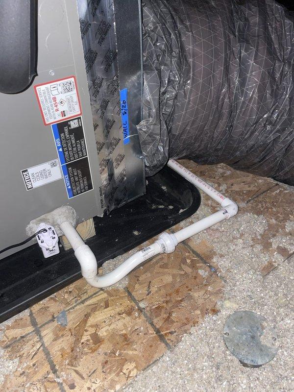 Completed HVAC system installation including air handler unit with 5KW heat kit, drain pan, and wet switch safety device. Installed two programmable White-Rodgers thermostats, new electrical disconnect with whip, 25x25 return air filter grill, and PVC condensate drain lines with proper trap configuration. Verified electrical service with correct breaker sizing and wire gauge for system requirements. Documentation photos captured for utility rebate program showing thermostat installation displaying 87°F room temperature with system calling for cooling at 74°F setpoint, and attic-mounted air handler with flexible ductwork and condensate drainage system properly installed on platform.