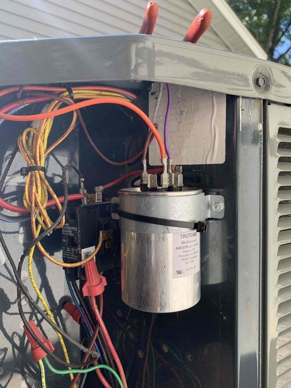 Responded to no cooling call on unit 10 located at side of home. Upon arrival, found system shut off as reported. Performed diagnostic evaluation and accessed outdoor condensing unit to inspect electrical components and wiring. Utilized digital diagnostic meter to test capacitor and electrical connections. Identified failed capacitor as cause of system malfunction. Documented equipment condition and wiring configuration with photographs showing capacitor, refrigerant lines, and electrical connections for service records.