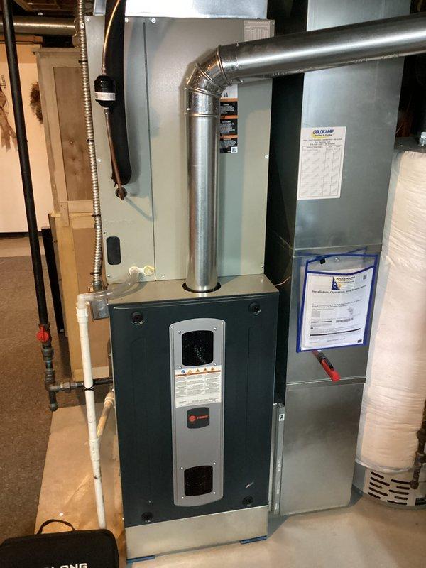 Completed preventive maintenance tune-up on a 1.5-year-old single-stage furnace system located in interior utility space. Performed comprehensive inspection of furnace unit and air handler assembly, including visual examination of all accessible components, electrical connections, and control systems. Verified proper operation of safety controls, tested thermostat communication, and inspected wiring harnesses for secure connections and proper routing. Checked blower motor operation, examined heat exchanger surfaces, and confirmed adequate clearances around equipment. Inspected condensate drainage system including PVC piping, verified proper venting configuration, and assessed ductwork connections for secure attachment and air seal integrity. System found operating within manufacturer specifications with no deficiencies noted. All components functioning properly with no immediate service needs identified.