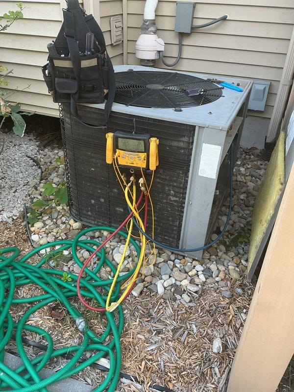 Responded to no cooling complaint on second floor 15-year-old Lennox system. Upon arrival, confirmed outdoor condenser unit running but indoor air handler not producing cool air. Connected manifold gauge set to service ports and performed refrigerant pressure analysis. System pressures indicated significant refrigerant undercharge. Conducted thorough leak inspection of both indoor evaporator coil and outdoor condenser coil. Inspected all refrigerant line connections, service valves, and accessible copper line sets for signs of refrigerant loss. Evaluated overall system condition noting age of equipment and wear patterns consistent with original installation. Documented findings with photos of outdoor unit with gauges attached and indoor air handler installation. Discussed system performance issues and repair options with customer. Due to age of equipment and extent of required repairs, customer elected to defer decision until Tuesday. Left system in safe condition with all service port