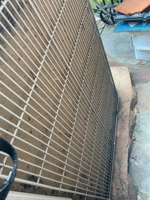 Completed preventive maintenance tune-up on ground-level cooling unit. Inspected and documented heavily soiled condenser coils with significant dirt and debris accumulation throughout finned surfaces. Checked air filtration system and documented Glasfloss pleated filters showing normal dust accumulation from service cycle. Performed standard O10 cooling system inspection including operational testing, refrigerant level assessment, electrical connections verification, and airflow evaluation to ensure proper system performance for continued reliable operation.