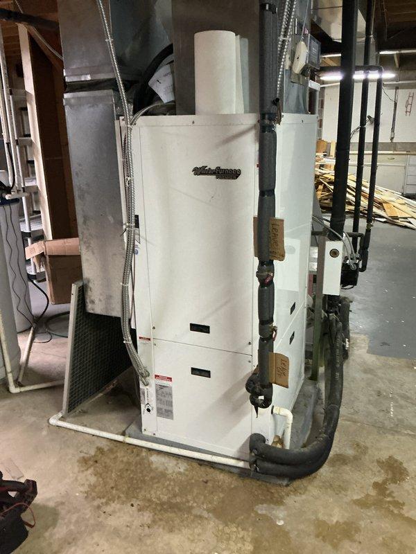 Responded to no cooling complaint on dual-zone geothermal WaterFurnace system located in basement. Inspected both 10-year-old units and associated hydronic components including expansion tank, water lines, and distribution piping. Advised customer to shut off air conditioning mode and leave fan running to prevent potential compressor damage while system issue is diagnosed. Documented equipment condition and installation configuration with photos for further evaluation.