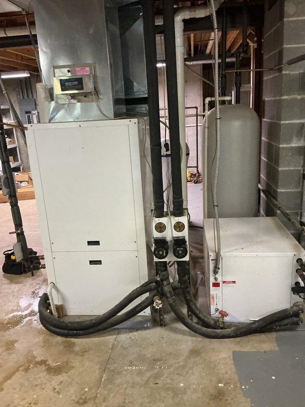 Responded to no cooling complaint on dual-zone geothermal WaterFurnace system located in basement. Inspected both 10-year-old units and associated hydronic components including expansion tank, water lines, and distribution piping. Advised customer to shut off air conditioning mode and leave fan running to prevent potential compressor damage while system issue is diagnosed. Documented equipment condition and installation configuration with photos for further evaluation.