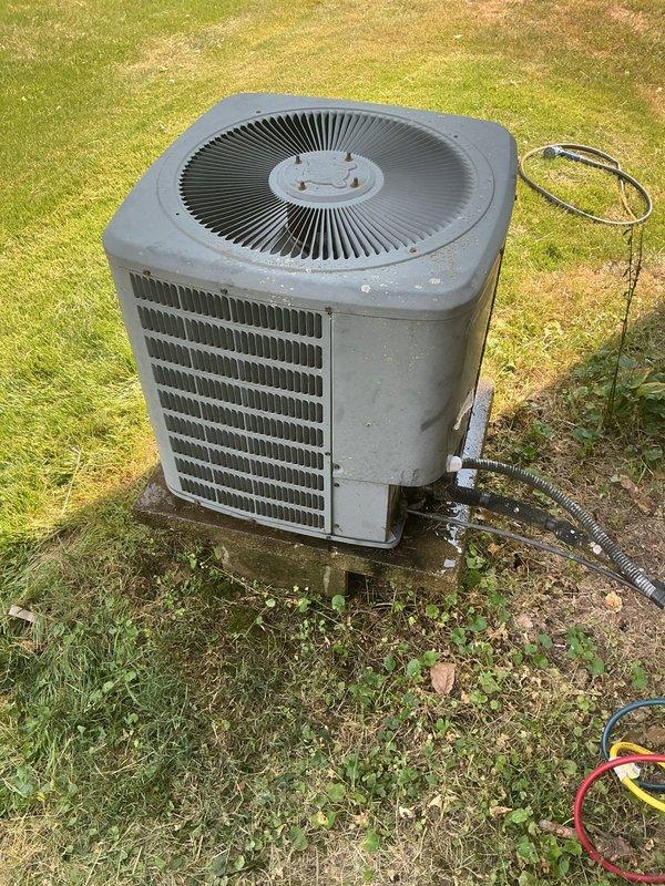 Responded to report of significantly increased electric bill at rental property. Inspected 16-year-old Goodman air conditioning system and found unit operating but running excessively due to low refrigerant charge. Located refrigerant leak at outdoor condenser unit service connections. Recovered remaining refrigerant, performed leak repair at line set connection points, pressure tested system to verify repair integrity, evacuated system to proper vacuum levels, and recharged unit to manufacturer specifications. Verified proper system operation with normal amperage draw and temperature differential across coil. Advised property owner that aging system should be monitored for additional efficiency concerns given age of equipment.