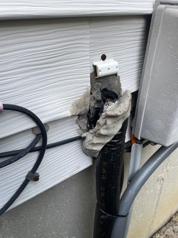 Responded to install callback for system displaying Error ID 411 with no cooling to any zones. Upon arrival, verified indoor temperature at 72.5°F and inspected outdoor unit. Discovered severely deteriorated line set penetration through exterior wall with compromised mounting pad and damaged conduit support. The concrete pad supporting the refrigerant lines showed extensive cracking and material failure, exposing interior cavities and creating potential for refrigerant line damage or restriction. Documented conditions with photos showing temperature readings and exterior damage to penetration assembly and mounting structure requiring immediate attention to prevent system failure.