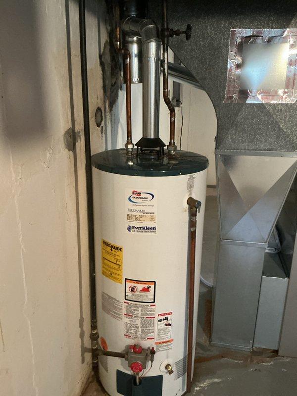 Replaced leaking 40-gallon natural gas water heater with new State Industries short model unit (G56 40-BDC5 400). Installed unit in basement utility area with proper copper piping connections, pressure relief valve, and venting. Applied permit identification sticker per permit 26plu-18140 requirements and ensured all manufacturer specifications and safety labels were properly displayed on unit.