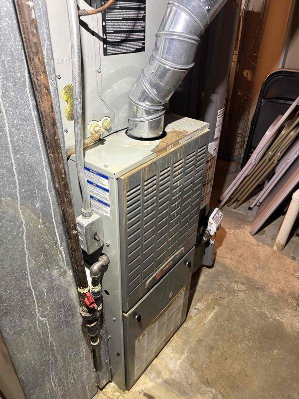 Completed comprehensive heating tune-up and safety inspection on 13-year-old residential furnace located in basement. Performed full system diagnostics, cleaned and inspected heat exchanger, verified proper combustion and gas pressure, tested all safety controls, and confirmed thermostat operation displaying 74°F with proper communication to heating system. All components found operating within manufacturer specifications with no immediate service needs identified.