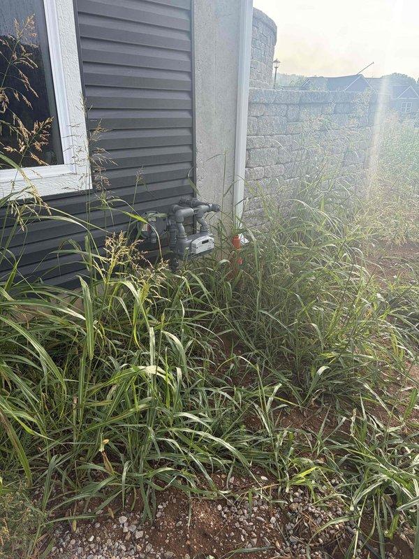 Conducted site assessment for 8-12kW generator installation at residential property. Evaluated existing electrical infrastructure including main service panel with multiple circuit breakers and available capacity for generator integration. Documented current HVAC condenser placement and exterior electrical conduit routing along building perimeter to determine optimal generator positioning and transfer switch location. Assessed site conditions including vegetation clearance requirements and concrete pad placement area near existing utility equipment. Photographed electrical panel circuit directory and exterior service area to develop comprehensive installation plan and material requirements for automatic standby generator system with required transfer switch and interconnection to main electrical service.