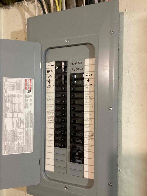 Conducted on-site electrical assessment for Kohler generator installation. Evaluated existing main electrical panel to determine compatibility and available capacity for generator integration. Panel inspection revealed fully utilized breaker spaces with handwritten circuit identification labels for main service, HVAC, kitchen appliances, garage circuits, and various room designations. Documented current electrical infrastructure including main breaker configuration, existing circuit distribution, and panel specifications to develop comprehensive installation estimate. Assessment included verification of service entrance capacity, evaluation of transfer switch placement requirements, and determination of necessary electrical modifications to accommodate automatic standby generator system.