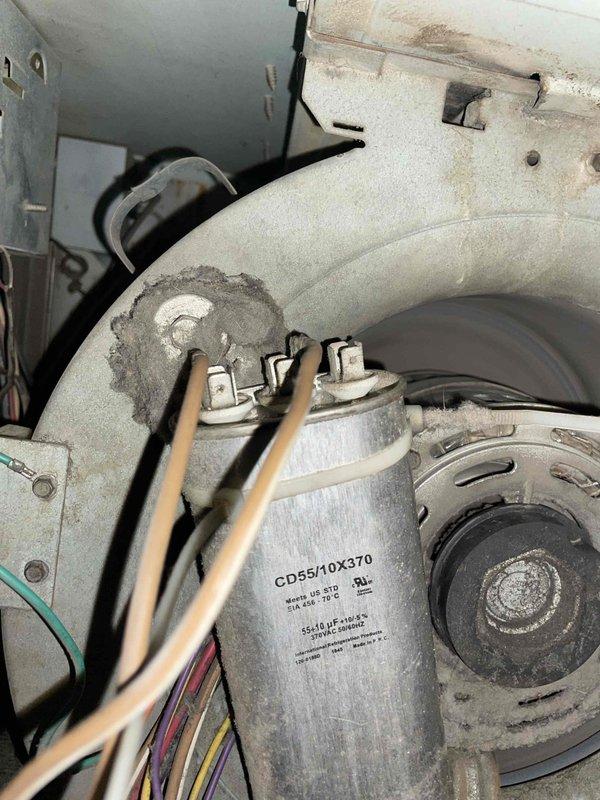 Completed comprehensive tune-up and maintenance service on a 10-year-old Lennox air conditioning unit located in backyard. Performed full system inspection including electrical connections, capacitor testing (CD55/10X370), and evaluation of all mechanical components within the unit's compartment. Cleaned accumulated dust and debris from internal components, verified proper electrical connections with multi-colored wiring harness, and confirmed operational status of motor assembly and heat exchange system through exterior louvered vents.