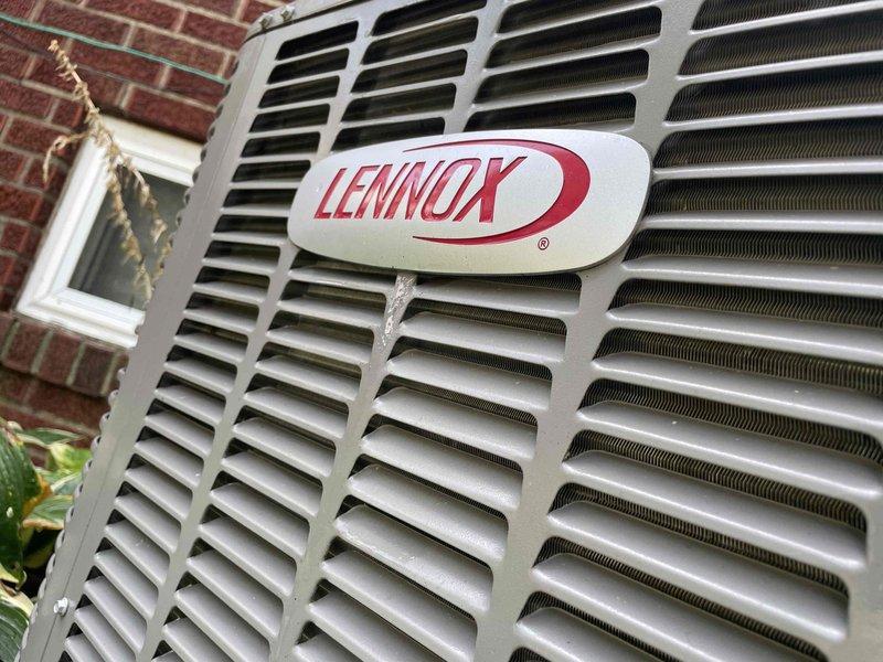 Completed comprehensive tune-up and maintenance service on a 10-year-old Lennox air conditioning unit located in backyard. Performed full system inspection including electrical connections, capacitor testing (CD55/10X370), and evaluation of all mechanical components within the unit's compartment. Cleaned accumulated dust and debris from internal components, verified proper electrical connections with multi-colored wiring harness, and confirmed operational status of motor assembly and heat exchange system through exterior louvered vents.