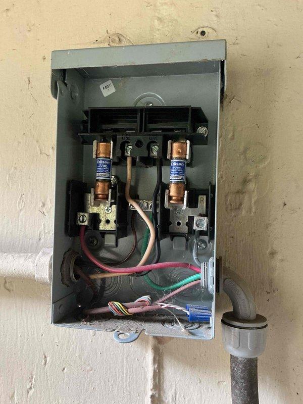 Responded to no cooling complaint on ground-level outdoor unit with recurring blown fuse issue from previous visit. Upon inspection, found condenser coils heavily clogged with dirt, dust, and debris causing restricted airflow and system overload. Inspected electrical disconnect box and confirmed cartridge fuses were functioning properly after previous replacement. Cleaned condenser coils to restore proper airflow and prevent future electrical overload conditions. Tested system operation and verified proper cooling function restored. Per customer request, left thermostat fan in ON position with AC system off.