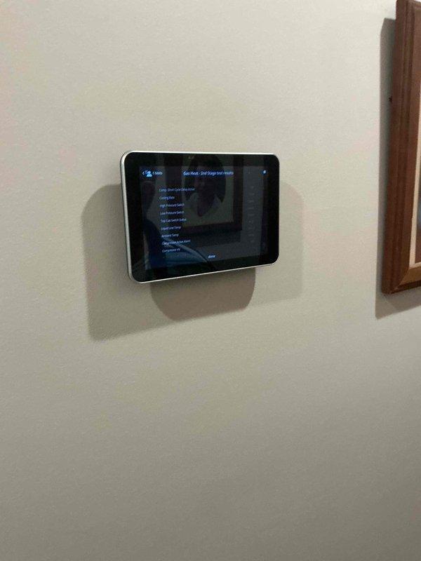 Completed scheduled heating maintenance tune-up on HVAC system serving second floor zone. Inspected wall-mounted digital touchscreen thermostat control panel, confirmed proper operation and menu functionality. Accessed air handling unit, removed and inspected air filter which showed significant dust accumulation with visible debris pattern across lower section; replaced filter with new unit to restore proper airflow and system efficiency. Verified heating system operational status, all components functioning within normal parameters at time of service completion.