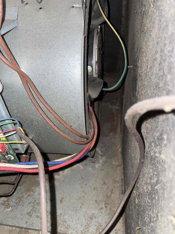 # HVAC Cooling System Tune-Up Completed

Performed comprehensive preventive maintenance tune-up on a single cooling unit over 10 years old located in backyard. Conducted standard seasonal inspection including filter assessment, electrical connection verification, and internal component evaluation. Return air grate showed significant dust and debris accumulation on interior surfaces, indicating reduced airflow efficiency. Inspected interior furnace/air handler components including control board, wiring harness connections, and blower assembly housing. All electrical connections including brown, red, blue, and yellow/green wires were examined for proper termination and signs of wear. Interior surfaces displayed normal operational dust accumulation consistent with unit age. System operational parameters verified and unit left in serviceable condition for continued cooling season operation.