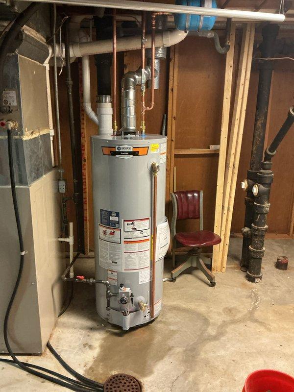 Completed installation of a 50-gallon tall gas water heater in a walkout basement utility area. Connected copper supply lines, PVC venting, and gas piping to manufacturer specifications, ensuring proper clearances and secure mounting. Applied required identification sticker and obtained permit compliance for final inspection.