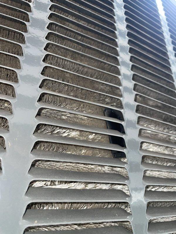 Responded to no cooling complaint on Unit 10 located at side of home. Upon inspection, discovered evaporator coil severely restricted with heavy accumulation of dust, dirt, and debris throughout fin structure, causing significant airflow restriction and reduced heat exchange capacity. Contamination was particularly dense on intake side with matted, fibrous buildup between fins. Documented conditions with photos showing extent of coil contamination and debris accumulation on both evaporator coil face and internal assembly. Refrigerant lines and coil assembly inspected for additional issues. System required thorough evaporator coil cleaning to restore proper airflow and cooling capacity.