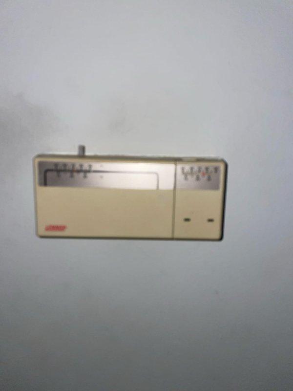 Responded to no cooling complaint on 20-year-old residential air conditioning system. Upon arrival, verified thermostat calling for cooling with no response from outdoor unit. Inspected outdoor condensing unit and found electrical control compartment heavily contaminated with dirt, debris, and insect nesting material affecting electrical connections and components. Cleaned and serviced electrical panel, inspected capacitor and contactor for proper operation. Tested system operation and restored cooling to residence. Recommended system replacement due to age and condition of equipment.