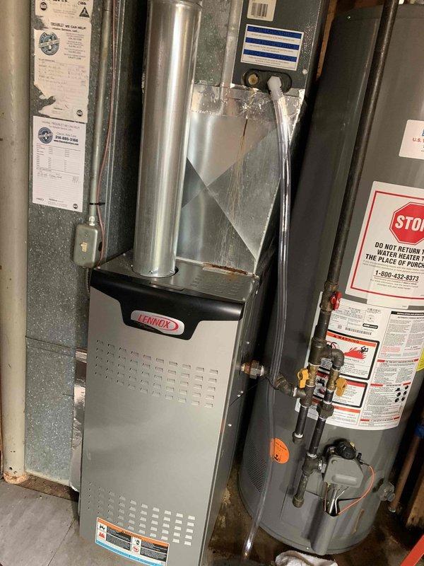 Responded to water leak complaint originating from air conditioning unit dripping onto Lennox furnace below. Upon arrival, performed diagnostic assessment of 2016 Goodman AC system and confirmed active condensate drainage issue. Customer had previously attempted drain line replacement without resolution. Inspected condensate drain system, identified blockage in primary drain line causing overflow condition. Cleared obstruction from drain line, verified proper drainage flow, and tested system operation under load. Confirmed leak was resolved and no water damage present on furnace components. Documented equipment conditions with diagnostic readings and photographic evidence of installation.